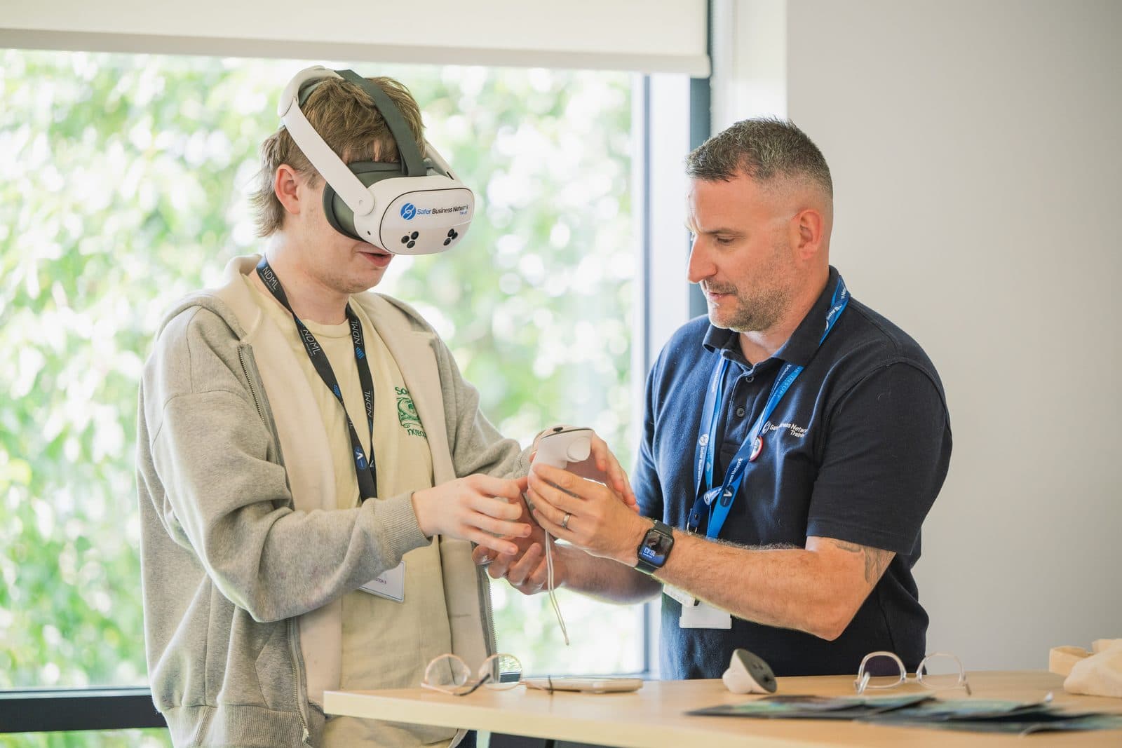 A trainer fitting a VR headset for a learner